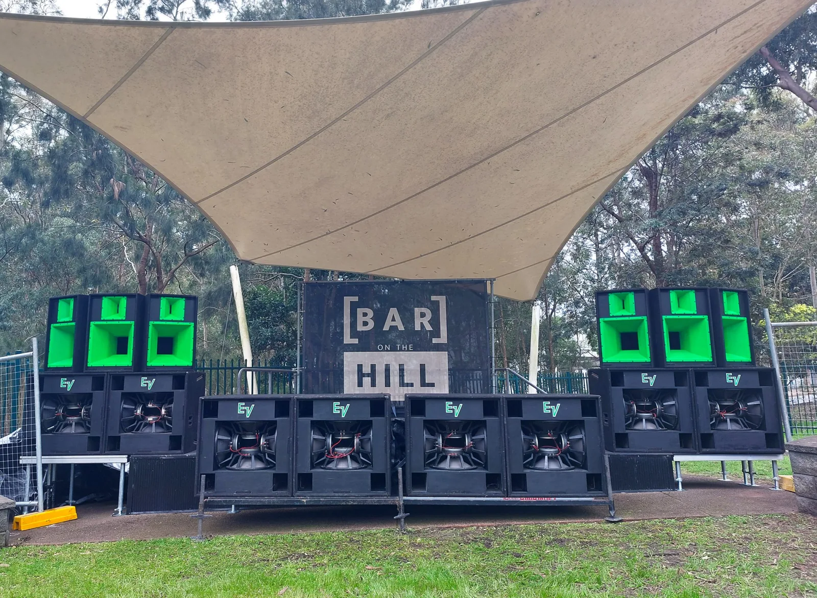 Festival sound system stacks either side of an outdoor stage
